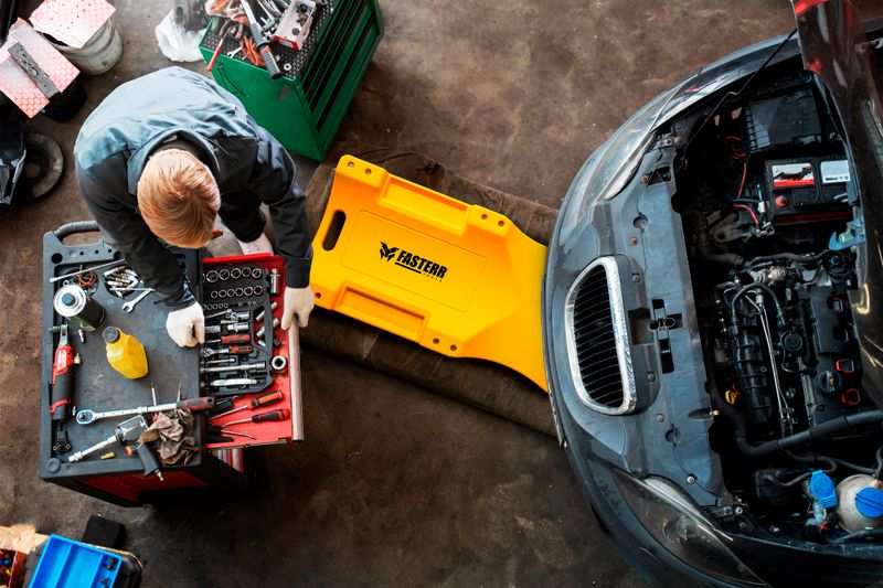 top-view-man-repairing-car.png